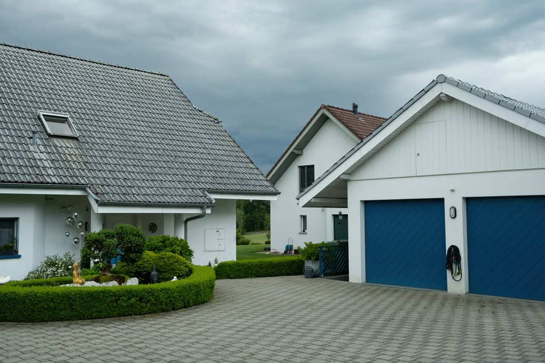  Suburban homes with garage doors representing routine garage door maintenance.