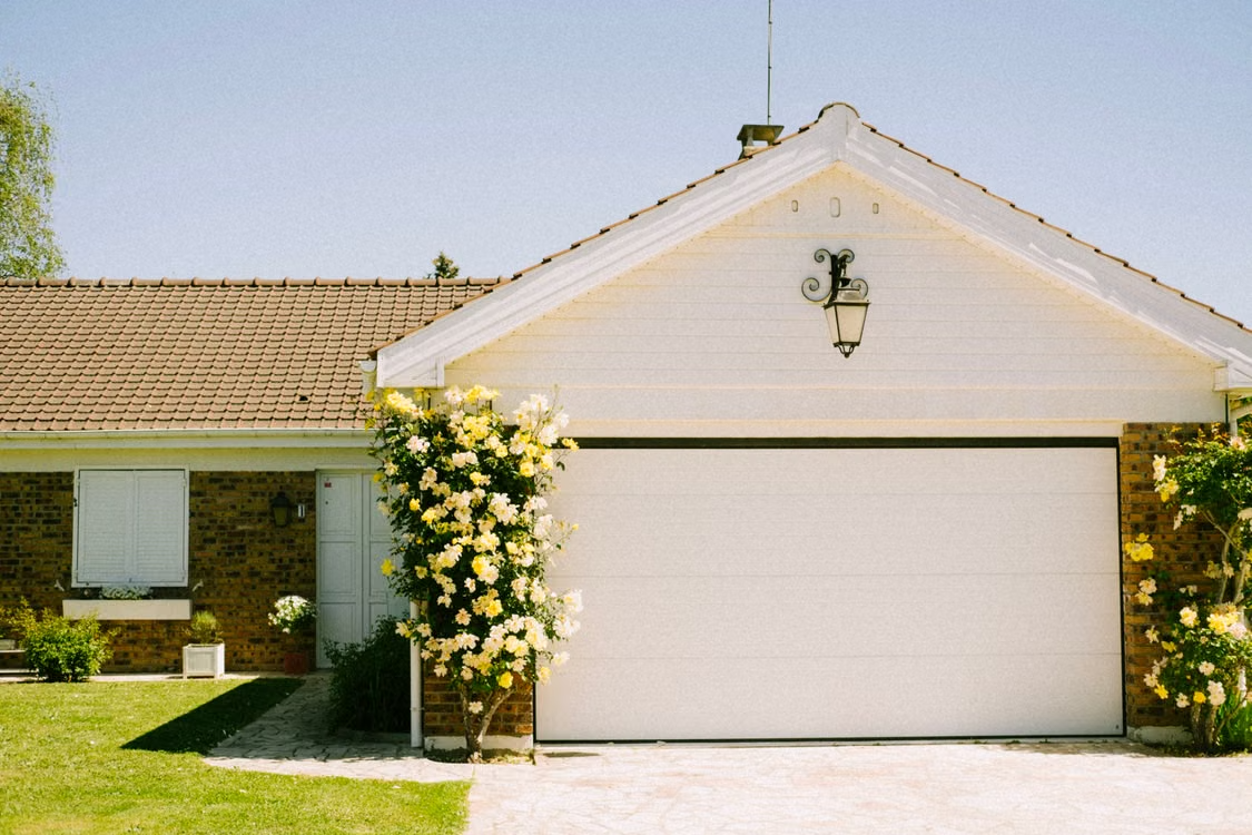 Suburban home with garage illustrating the importance of balanced door operation.