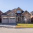Residential home with a garage door highlighting common garage door opener problems and the need for professional repair.